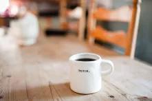 the word "begin" written on a mug which stands on a table