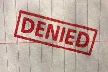 "denied" stamp on paper