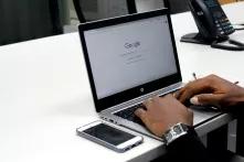 PoC/black persons hands typing on laptop