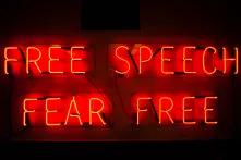 neon sign "free speach. fear free"