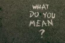 the words "what do you mean?" written on concrete floor