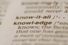 camera focus on the word "knowledge" in a dictionary