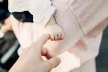 babys hand grabbing adults hand