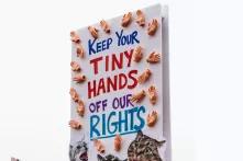 poster on demonstration saying "keep your tiny hands of our rights"