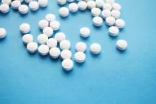 round white pills on blue surface