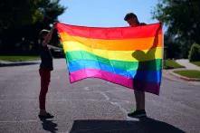adult and child holding rainbow flag