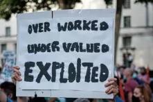 demonstration poster "over worked under valued exploited"
