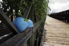 Two blue helmets on a bridge.