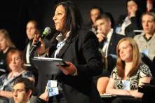 Young Women Talking into a Microphone
