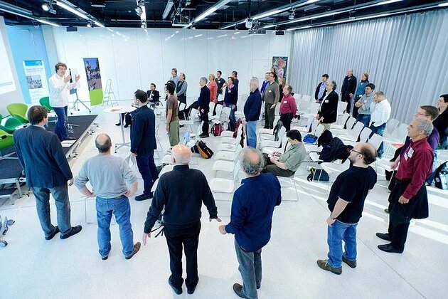 Workshop "Männer - Stimme - Körper" Teilnehmer_innen des Workshops stehen im Halbkreis.