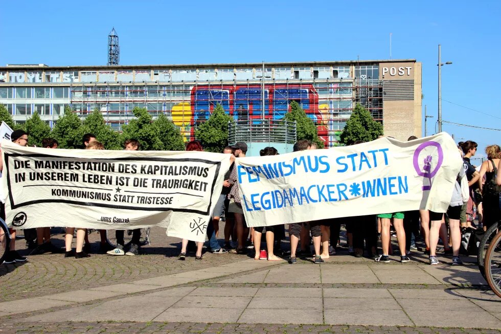 Demo Leipzig, transparente Feminismus statt Legidamacker*innen und Die Manifestation des Kapitalismus in unserem Leben ist die Traurikkeit. Kommunismus statt Tristesse